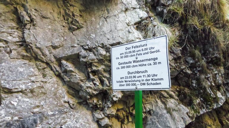 Das Schild, das über den Felssturz und den Dammbruch informiert