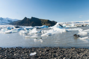 Weiße Eisberge vor fast schwarzem Doppelgipfel