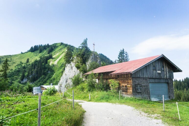 Auf dem Felsen steht ein Gipfelkreuz. Heute sparen wir uns diesen Aufstieg